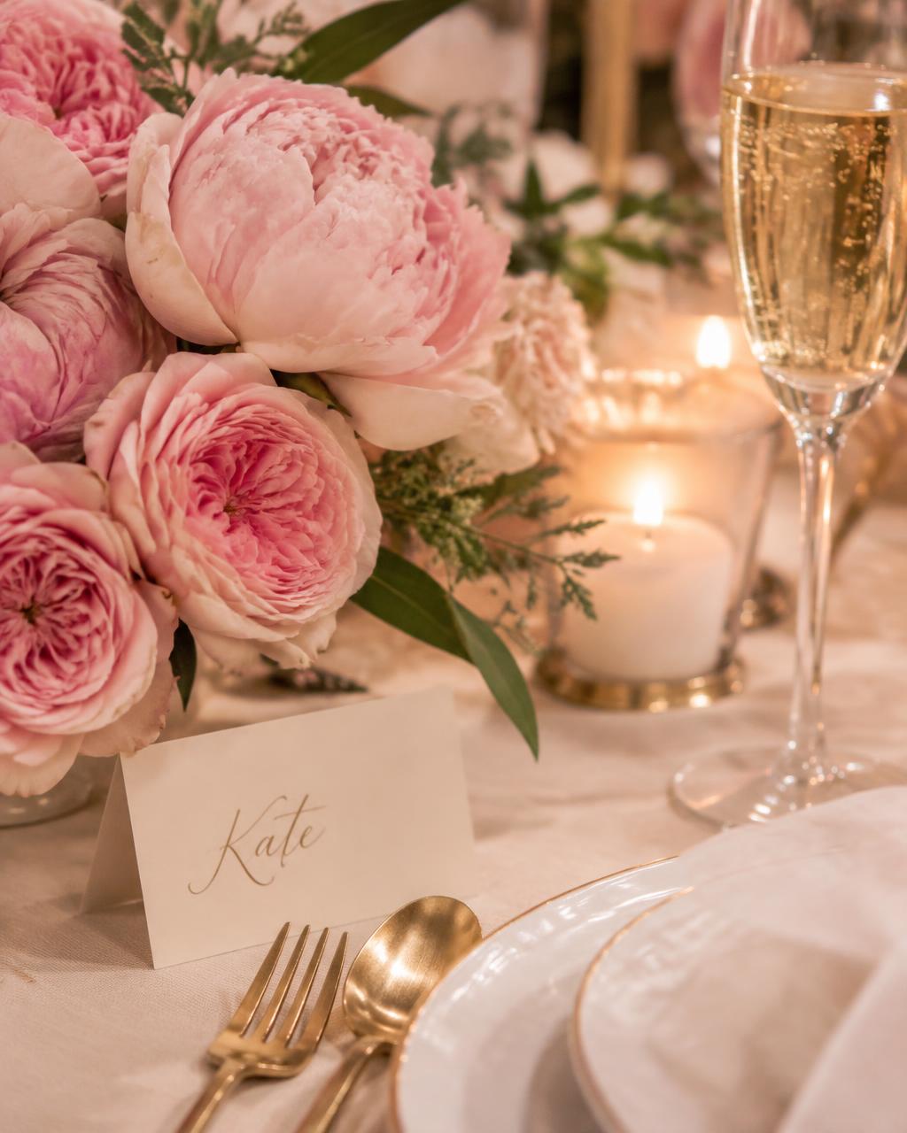 Blush roses, candlelight, and a calligraphy place card